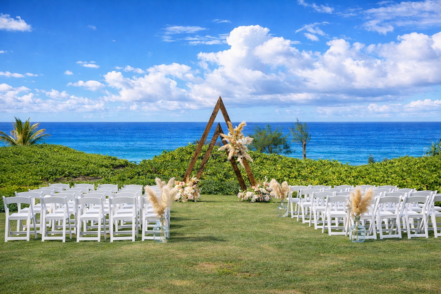 Ceremony chairs set on the lawn facing the Pacific with a floral wooden arch